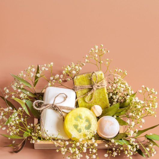 spa-body-care-accessories-wooden-box-colored-background